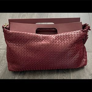 Bottega Giotti burgundy large clutch with shoulder strap.